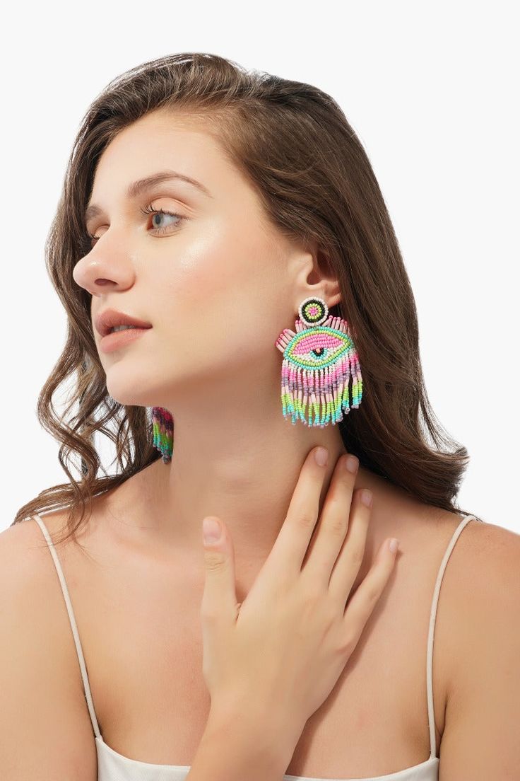 Evil Eye Beaded Earrings Hand-beaded Crafted in beautiful colors of pink, green, purple & blue Party girl by night and Zen guru by the day? If so, then look no further! These pink lazy eye earrings were basically made for you. So let your ears do all the talking for a change. After a night out on the town, this piece is your perfect companion as you laze around the pool or munch on breakfast pastries. Your vacay simply has to have this vibe setter. Make heads turn with your contemporary style as Colorful Dangling Beads Earrings For Party, Colorful Beaded Dangling Earrings For Party, Pink Beaded Drop Earrings For Festivals, Handmade Multicolor Beaded Earrings For Party, Pink Festival Earrings With Colorful Beads, Colorful Beaded Earrings For Gifts, Colorful Fun Beaded Earrings As Gift, Bohemian Multicolor Beaded Earrings For Party, Trendy Multicolor Beaded Earrings For Summer