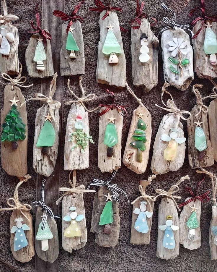 christmas ornaments are hanging on wooden boards and tied with twine strings, along with other decorations