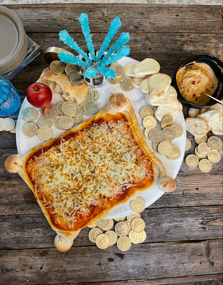 a square pizza sitting on top of a white plate covered in cheese and toppings