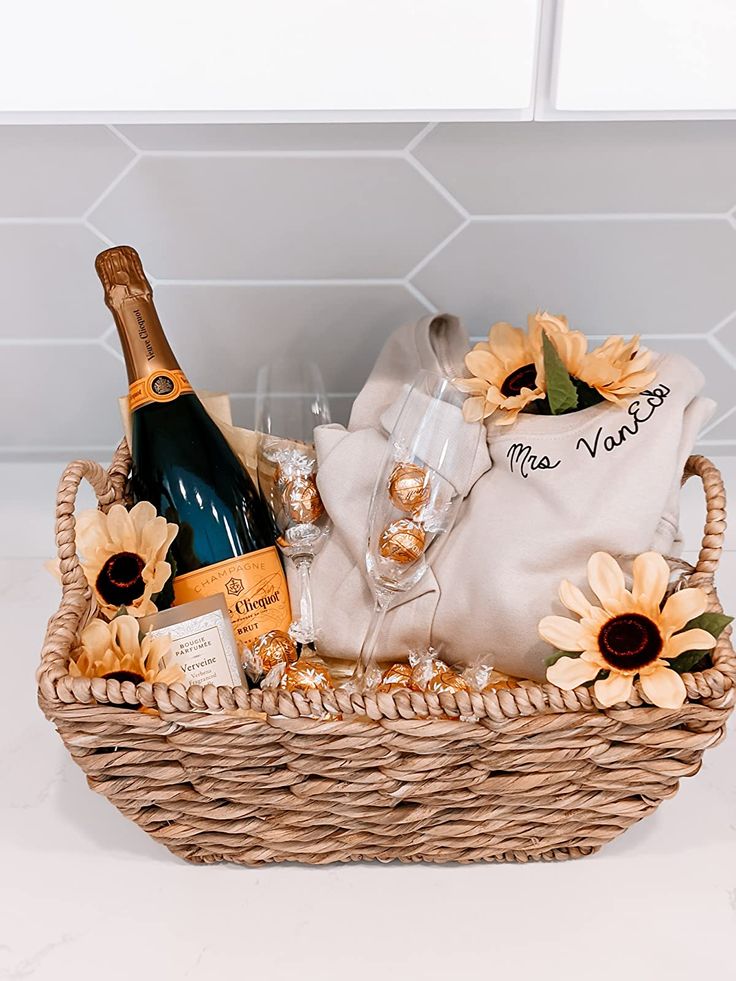 a wicker basket filled with champagne and sunflowers