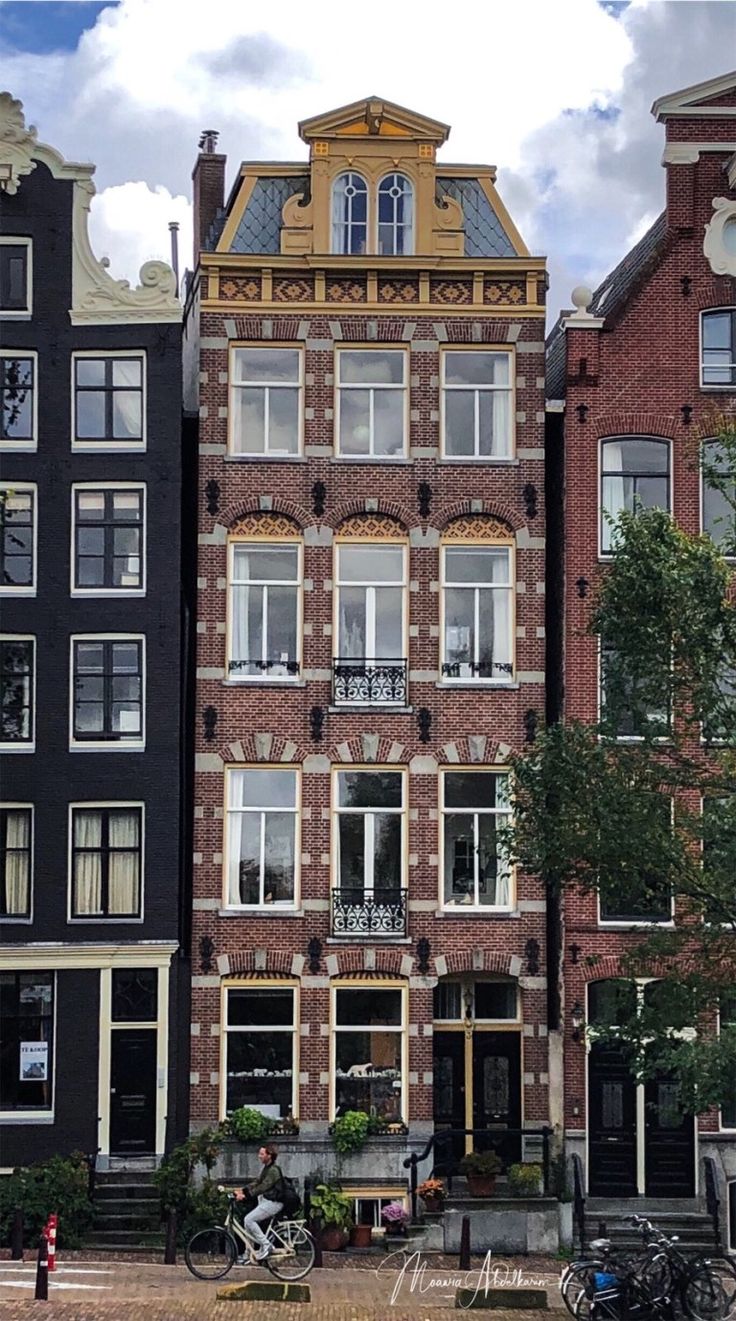 a row of brick buildings with bicycles parked in front