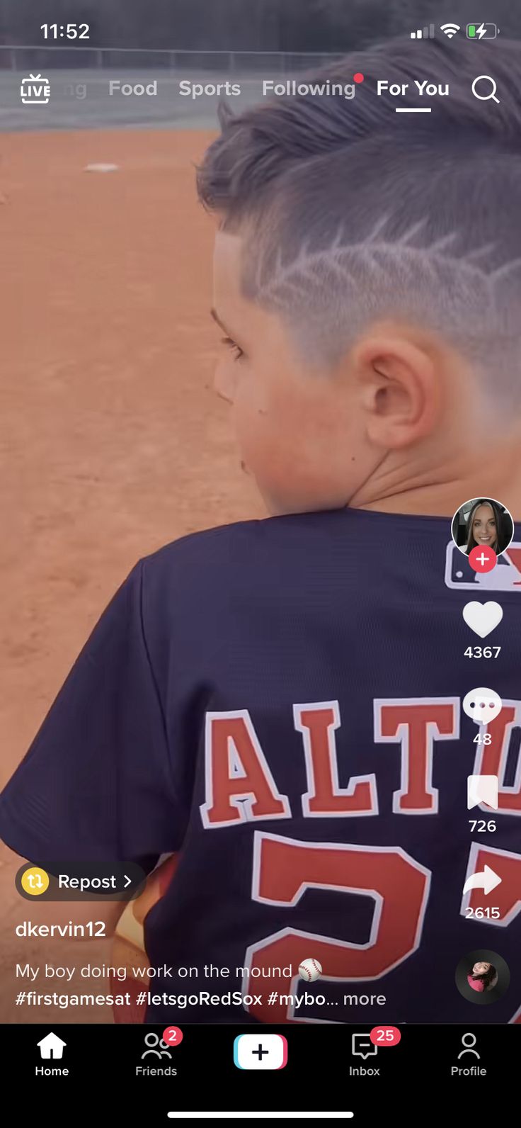 a little boy with a baseball uniform on and his hair styled into a pomp undercut