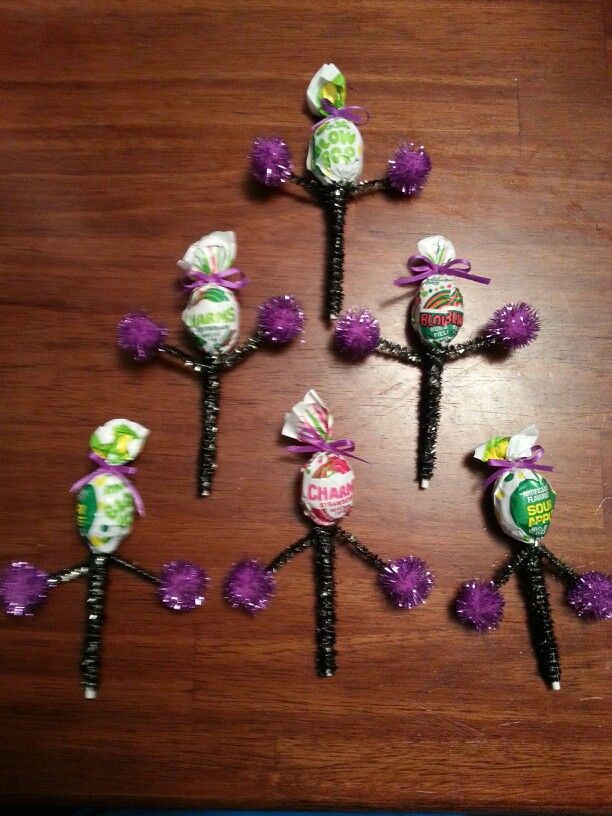 six candy lollipops are arranged on a table