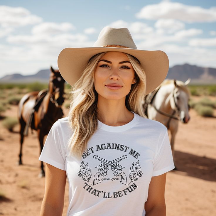 Bet Against Me That'll Be Fun Pistols t-shirt for country girls and cowgirls is a Next Level brand tee and comes in unisex cut and sizes. This graphic tee features guns and roses so to speak with its six-shooter pistols crossed in the center and pretty dainty flowers on each side. Cowgirls have a soft side until you cross them, right? This graphic tee for cowgirls is a personal favorite since my daddy called me Annie Oakley growing up. A vintage style graphic for the modern cowgirl. Looks perfec Six Shooter, Nashville Bachelorette Party, Annie Oakley, Modern Cowgirl, Cowgirl Outfit, Dainty Flowers, Nashville Bachelorette, Its A Mans World, Party Music