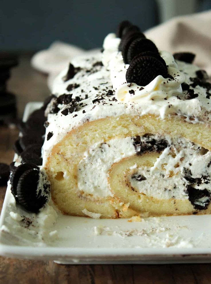 a close up of a cake on a plate with oreo cookies and cream frosting