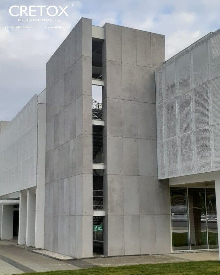 the building is made out of concrete and has many windows