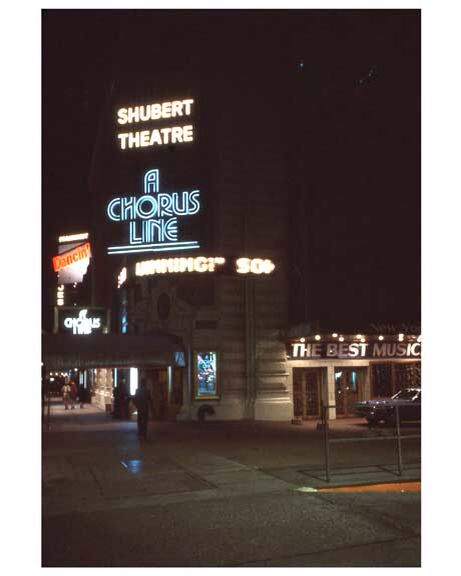 an old theater sign lit up at night