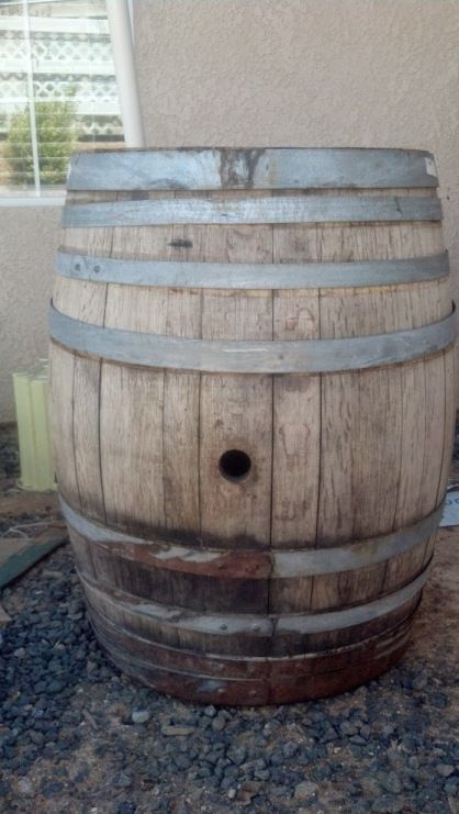 an old wooden barrel sitting on the ground