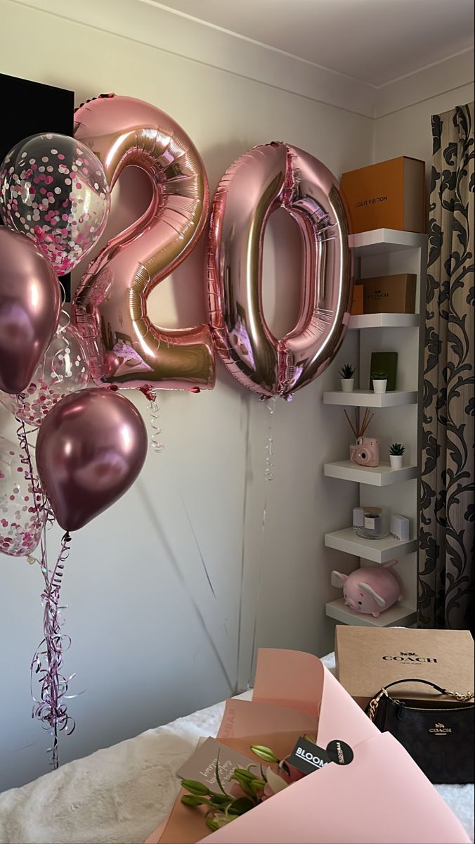 some balloons that are in the shape of numbers on a wall with other items around it