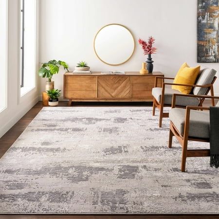 a living room area with two chairs and a rug