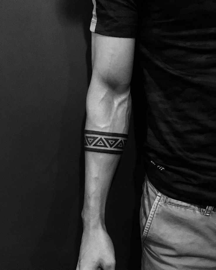 a man with a black and white tattoo on his arm