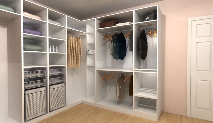 a white closet with clothes hanging on the shelves