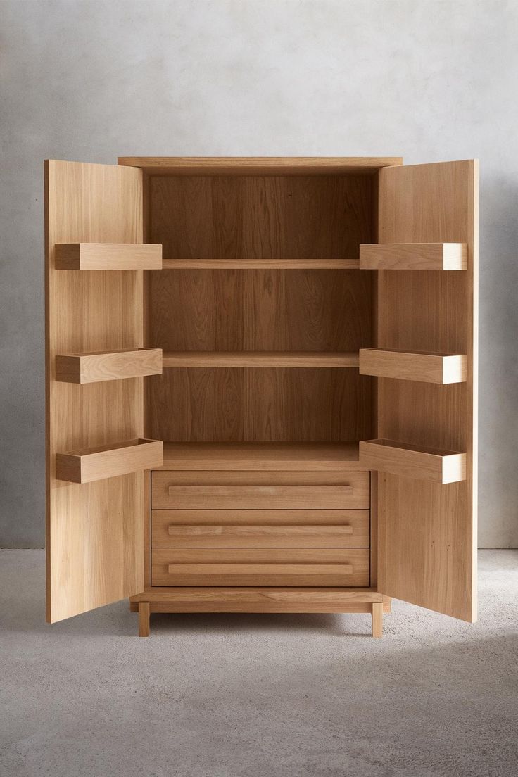 an open wooden cabinet sitting on top of a cement floor