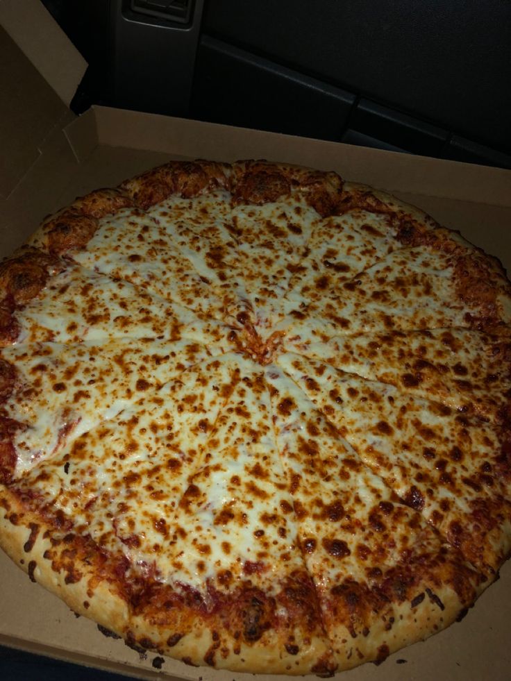 a large cheese pizza sitting in a box