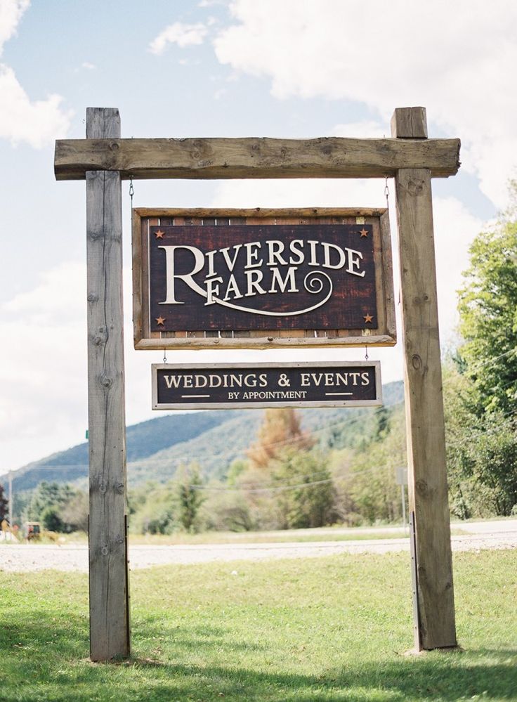 a sign for riverside farm wedding and events