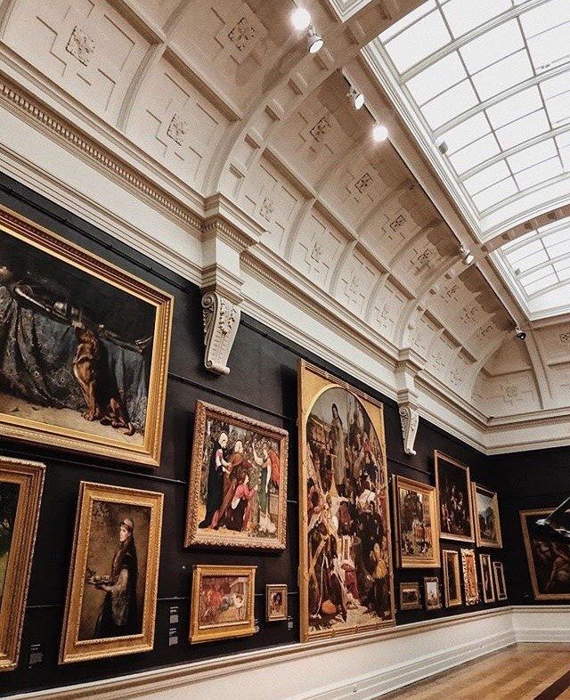 an art gallery with many paintings on the wall