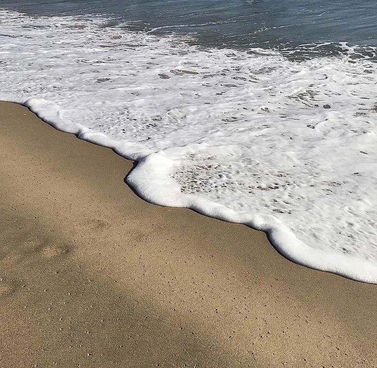 the beach has waves coming in to shore