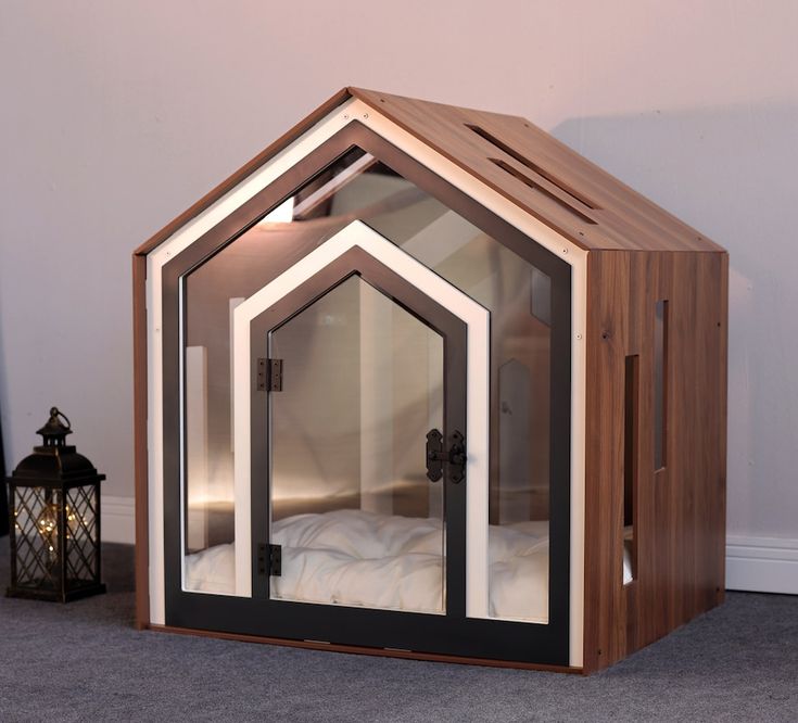 a bed in a small wooden structure with glass doors on the front and side sides