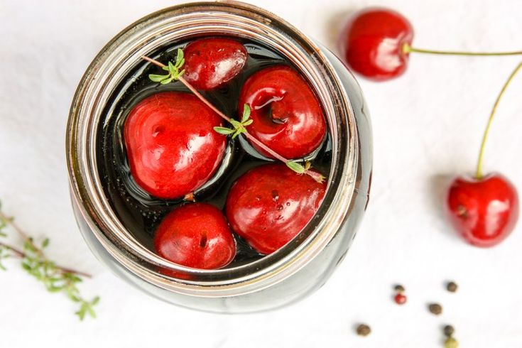 two pictures with cherries in them and the words balsamic pickled cherries