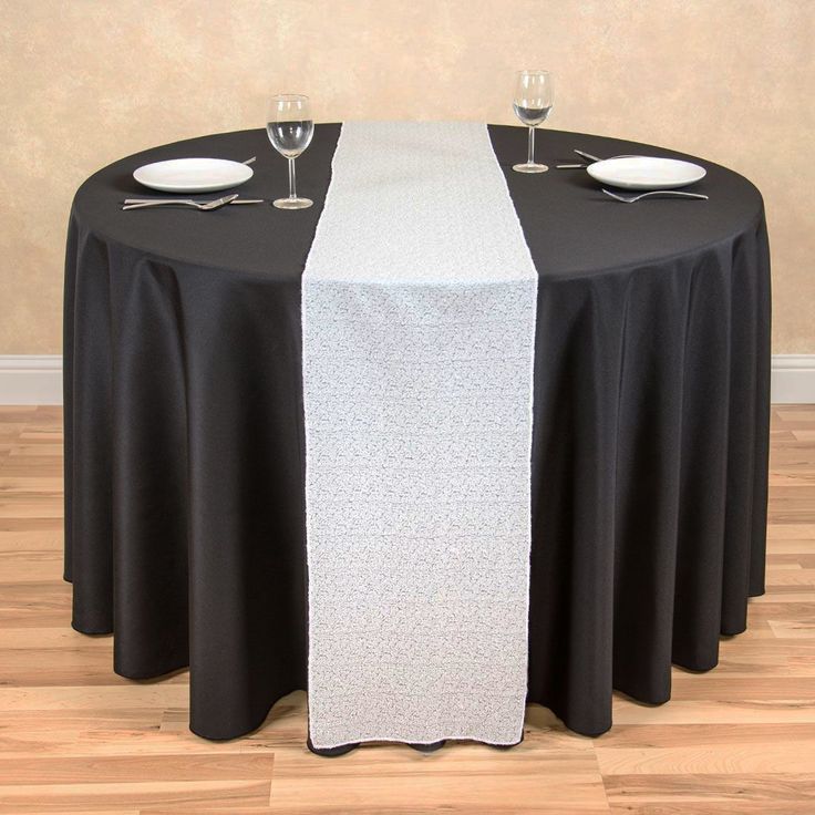 the table is set with black and white linens