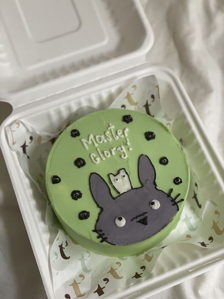 there is a cake in the shape of a bunny on top of a plastic container