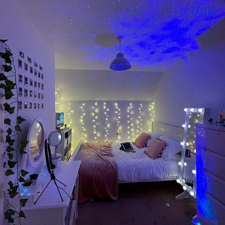 a bed room with a neatly made bed and lots of lights