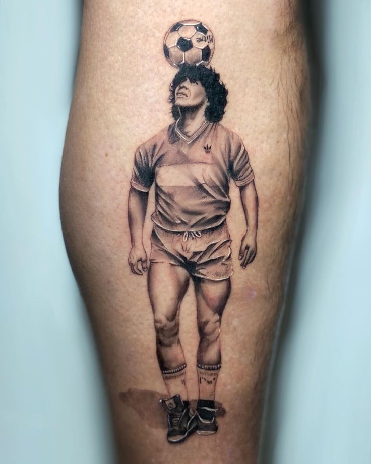 a man with a soccer ball on his head is shown in this tattoo art photo