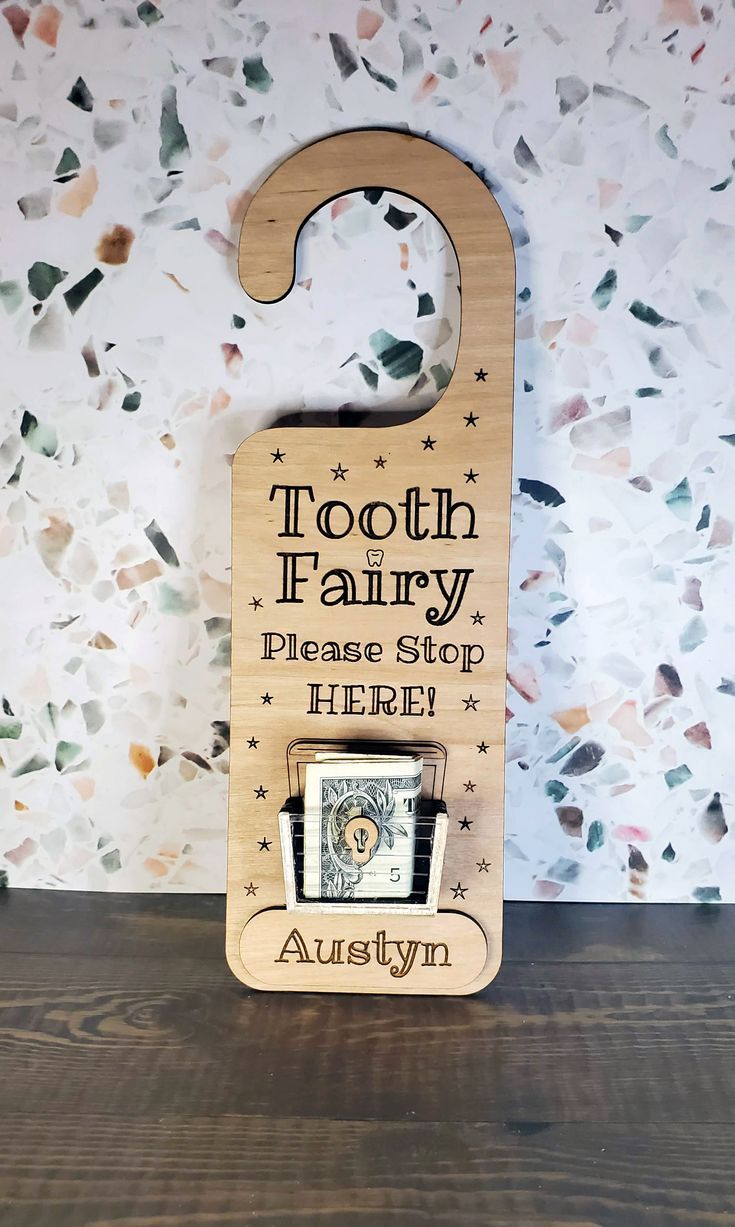 tooth fairy please stop here wooden sign with photo frame on wood table against white wall