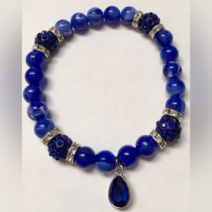 A Stunning Stretchy Bracelet With Gorgeous Royal Blue Beads With White Streaks, Beautiful Royal Blue Rhinestone Crystal Ball Beads, Silver Rhinestone Spacers, And A Silver Plated Royal Blue Tear Drop Charm Nwot- Never Worn Or Used From A Smoke Free Home *Specially Handcrafted Blue Crystal Beaded Bracelets For Jewelry Making, Elegant Blue Stretch Bracelet With Faceted Beads, Elegant Blue Beads Bracelet, Elegant Blue Bead Bracelet, Elegant Blue Crystal Beaded Bracelets, Elegant Blue Beaded Crystal Bracelet, Blue Crystal Beaded Bracelets, Blue Crystal Bracelet With Polished Round Beads, Blue Crystal Bracelet With Stones For Gift