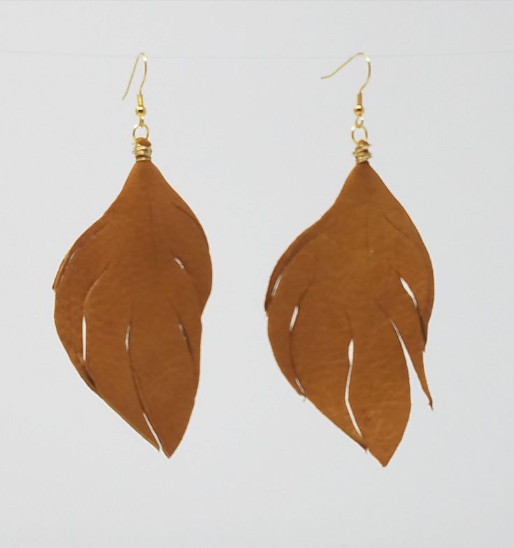 Repurposed leather leaf shaped earrings. Bohemian style earrings approximately 2" in length. Available in red, black, brown or camel with gold or silver accents. Every item sold plants a tree through our partnership with One Tree Planted. Bohemian Brown Leaf-shaped Earrings, Leaf Earrings Silver, Leather Leaf Earrings, Leather Leaf, Gold Leaf Earrings, Purple Agate, Amethyst Gold, Earrings Bohemian, Gold Filled Earrings