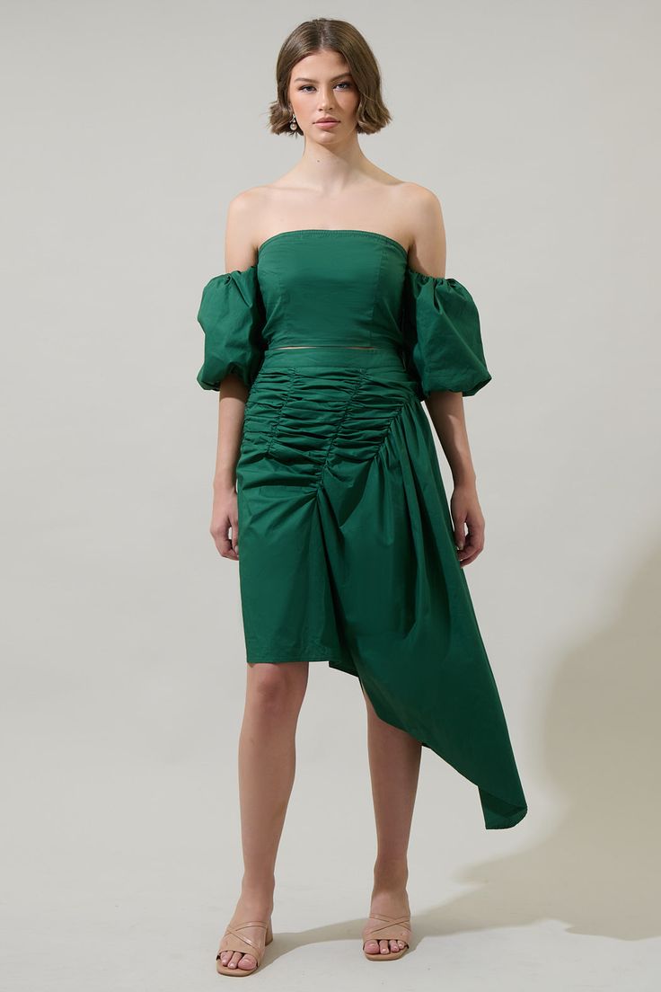 Be ready to stand out from the crowd in this Jadey Belen Ruched Midi Skirt. An extra stunning asymmetrical design fits perfectly in this ruched midi skirt. An invisible zipper was added in the side. You can wear it with the matching crop top and heels.- Ruched- High waist- Breathable- Asymmetrical- Color: EmeraldSize + Fit - Model is 5'8" and wearing size XS- Measurements taken from size S - Waist: 13 1/4"- Length: 37 1/2" Fabric Self:100%Cotton Style Number STS7063DR Chic Ruched Maxi Skirt For Party, Chic Party Maxi Skirt With Ruched Details, Spring Midi Skirt With Gathered Waist, Chic Draped Fitted Maxi Skirt, Evening Draped Asymmetrical Skirt With Ruched Sides, Evening Draped Skirt With Ruched Asymmetrical Hem, Evening Draped Skirt With Ruched Sides And Asymmetrical Shape, Ruched Maxi Skirt For Night Out, Ruched Midi Party Skirt