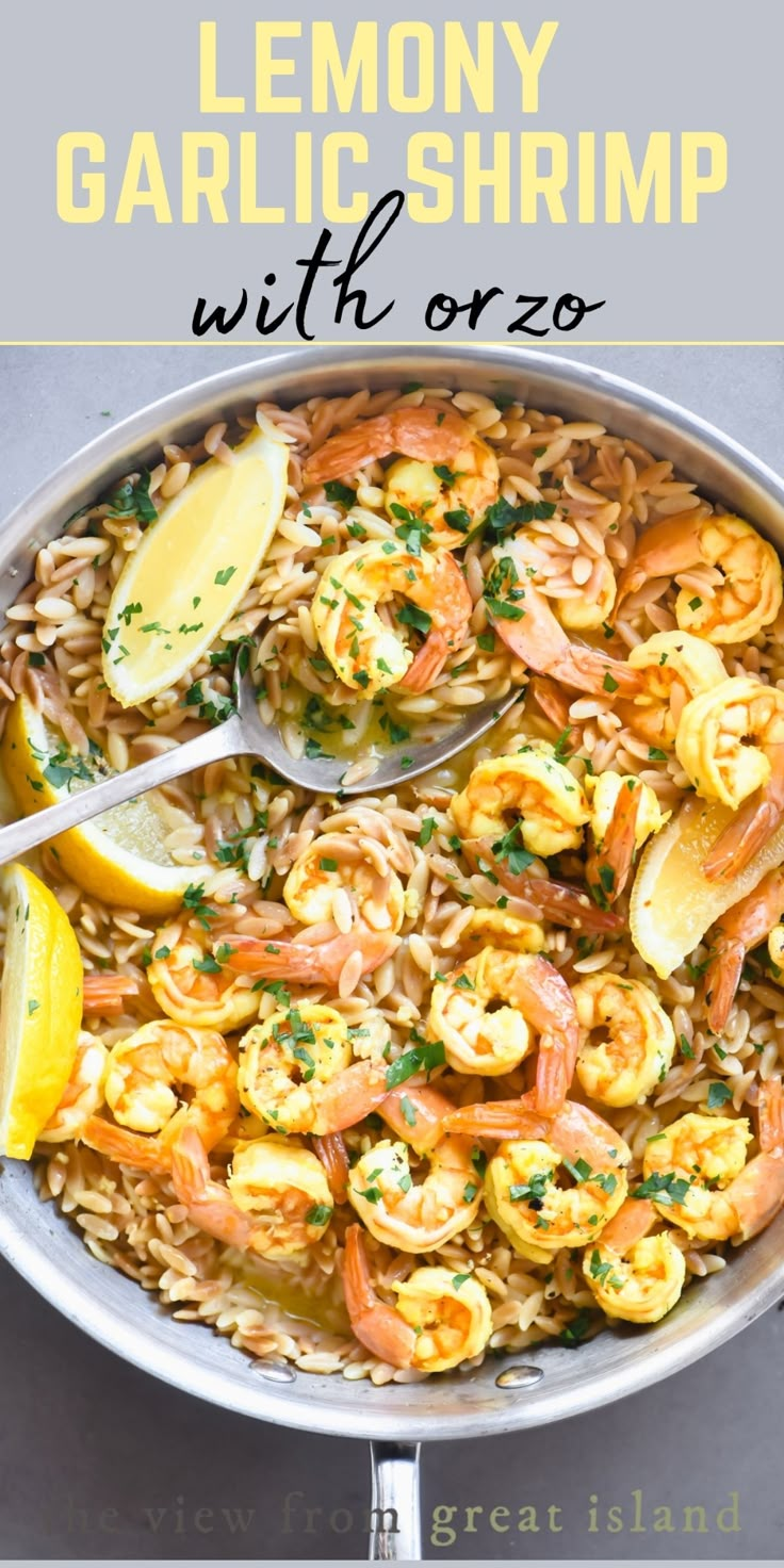 a skillet filled with pasta and shrimp, garnished with lemon wedges