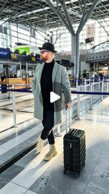 a man is walking with his luggage in an airport