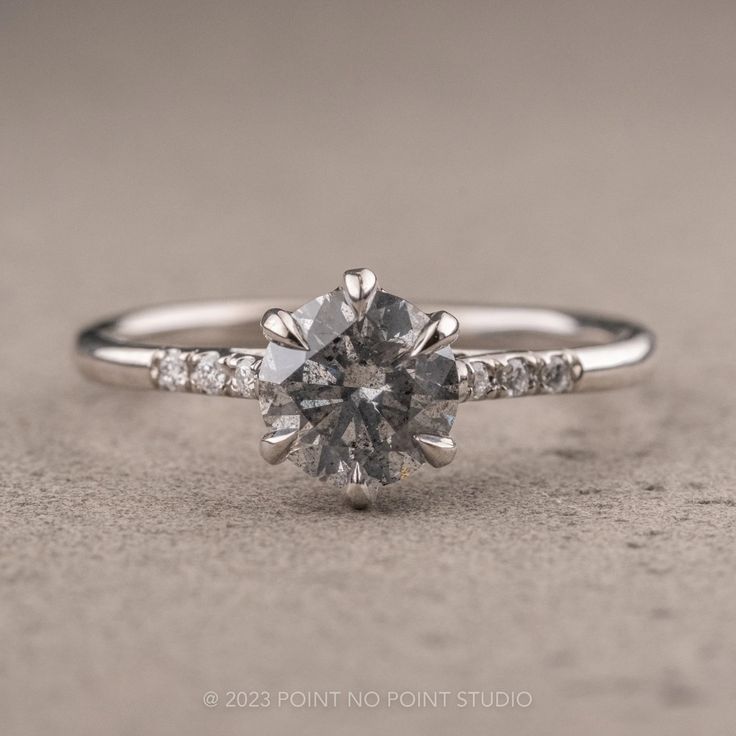 a white gold engagement ring with diamonds on it