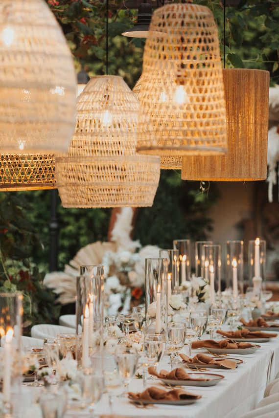 a long table is set up with candles and place settings