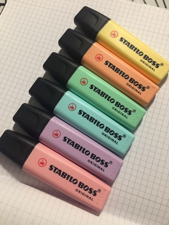 five different colors of sharpies are lined up in a row on a sheet of paper