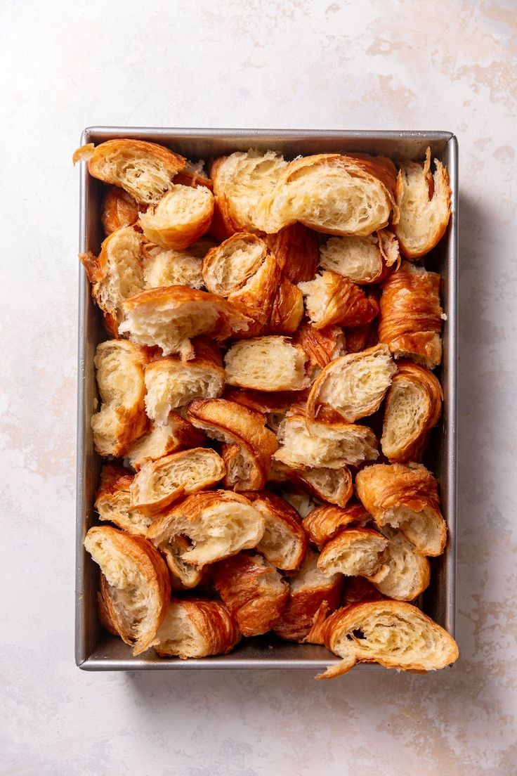 a pan filled with croissants sitting on top of a white countertop