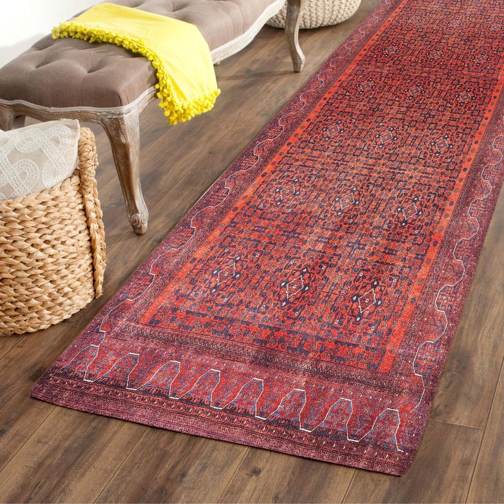 a large red rug on the floor in a living room