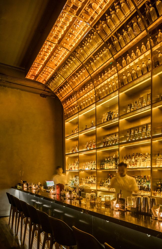 a bar with many bottles on the shelves