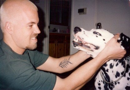 a man petting a dalmatian dog with a caption in front of him