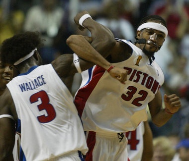 two basketball players colliding for the ball during a game