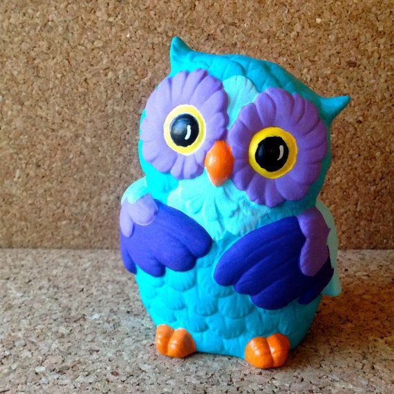 a blue and purple owl sitting on top of a counter