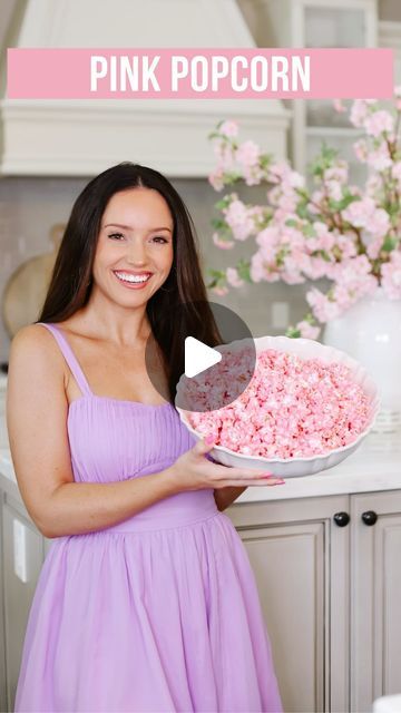 a woman in a purple dress holding a bowl of pink popcorn with the words pink popcorn on it