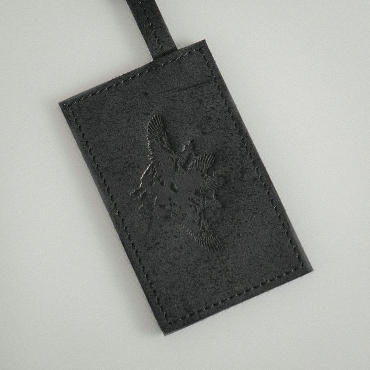 The charcoal black, raw matte calf leather is used inside out allowing the material to reveal factory marks and bruises, providing each piece with a unique character. Every piece is handcrafted in Budapest, Hungary. Wipe with a damp cloth, buff with a dry cloth, cleaning by a specialist.  SIZE AND FIT Width: 7 cm, Height: 11 cm, Strap Length: 50 cm FABRIC 100% Calf Leather  Shell, 100% Calf Leather Trim CARE Wipe with a damp cloth, buff with a dry cloth, cleaning by a specialist. Organza Top, A Perfect Circle, Budapest Hungary, Charcoal Black, Cynthia Rowley, Independent Designers Fashion, Ulla Johnson, Black Charcoal, Leather Trim