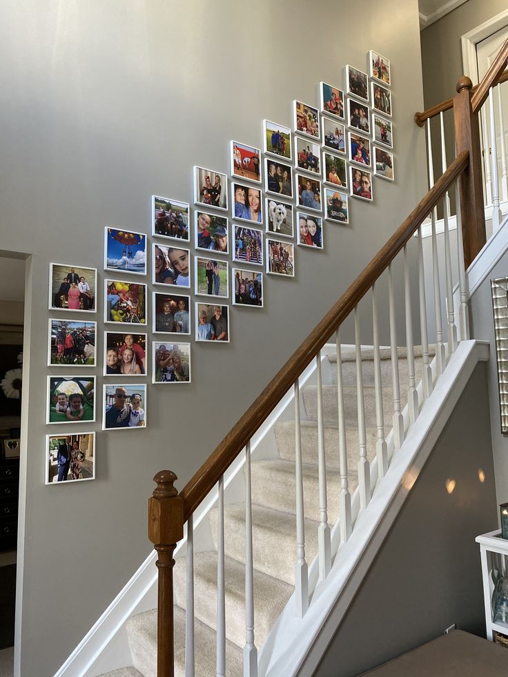 the stairs are decorated with pictures and frames