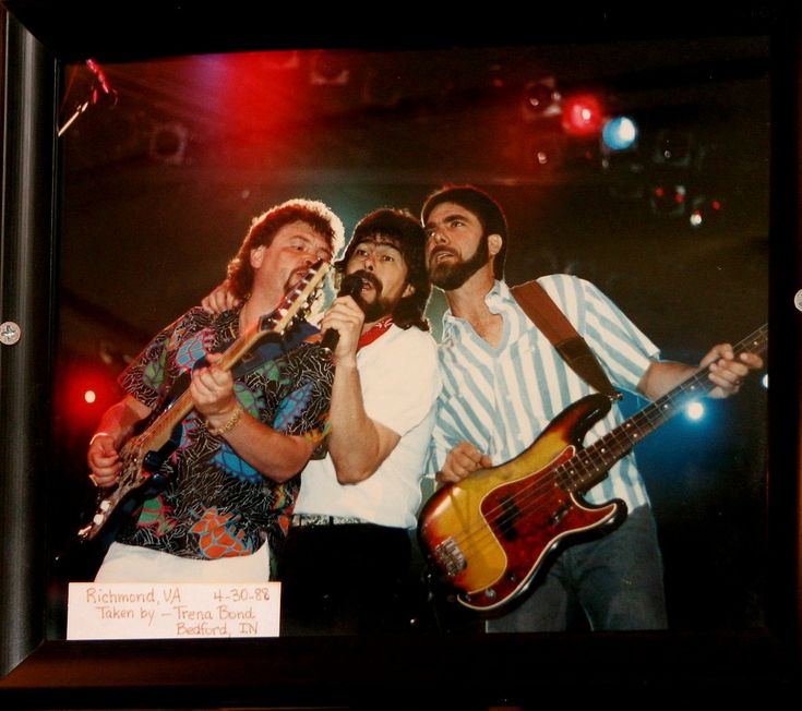 a group of people that are holding guitars