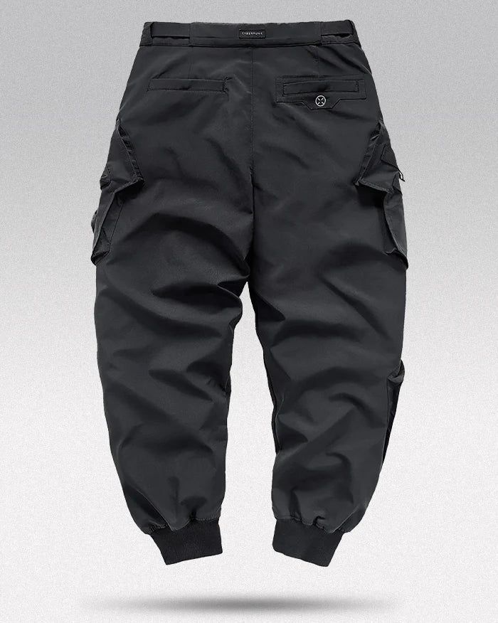 * Cargo pants "Ichihara" are in Asian size:  Take one size bigger than your usual size.   Command the Streets: "Ichihara" Techwear Pants Step into the urban jungle with the "Ichihara" Techwear Pants . These pants are designed for those who don’t just walk the city—they own it. With a mix of functionality and sleek design, "Ichihara" is your go-to for making a statement on the streets.  Size Guide (cm) Size Waist (cm) Hips (cm) Length (cm) Leg Opening (cm) M 82 106 97 23 L 86 110 99 23 XL 90 114 Techwear Sweatpants With Side Pockets For Outdoor, Hip Hop Cargo Pants With Hip Pockets For Outdoor, Hip Hop Bottoms With Cargo Pockets For Outdoor, Techwear Tapered Leg Parachute Pants With Pockets, Techwear Parachute Pants With Pockets, Techwear Parachute Pants With Tapered Leg And Pockets, Techwear Cargo Style Bottoms For Outdoor, Baggy Techwear Pants With Cargo Pockets, Hip Hop Parachute Pants With Side Pockets For Winter