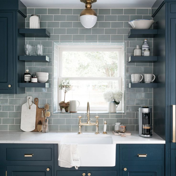 a white sink sitting under a window in a kitchen