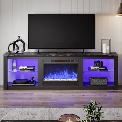 a living room with a large television and fire place in front of the flat screen tv