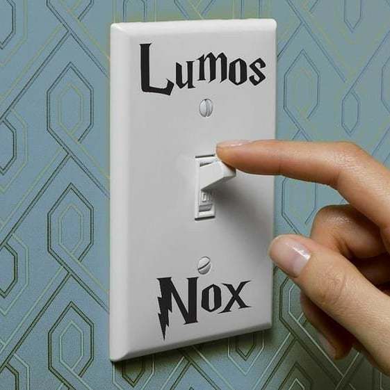 a person turning on a light switch with the words lumos and nox printed on it